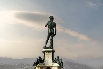 Rear view of the bronze copy of the famous David by Michelangelo, in Piazzale Michelangelo against cloudy sky, Florence, Tuscany, Italy