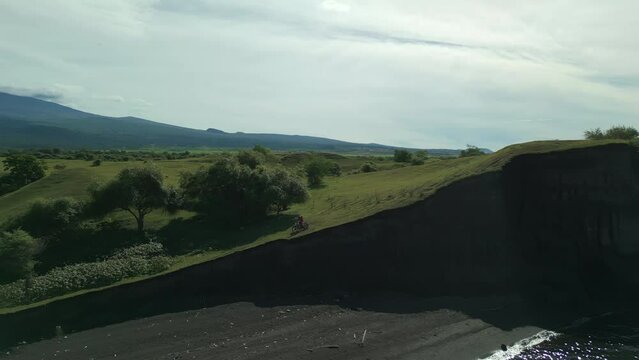 enduro motorcycle rides along the shore National Park. View Tambora Mountains