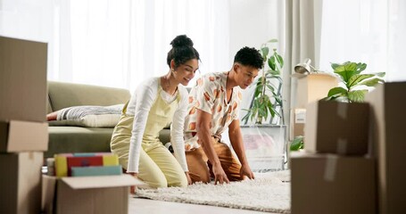 Apartment, teamwork and couple rolling a carpet on floor in new home, house or living room. Smile, property furniture and man with woman moving in real estate with boxes, rug and excited unpacking