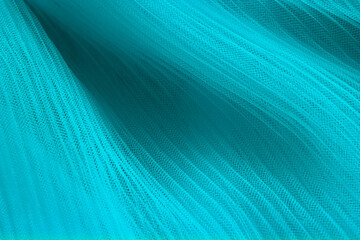 closeup of turquoise corrugated organza textured background