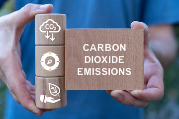 CO2 Carbon Dioxide Emissions Manufacturing Reduction concept. Eco Business Industry. Man holding...