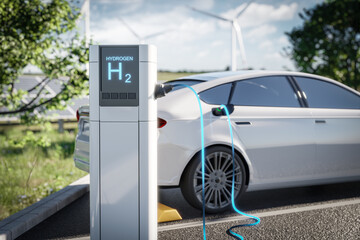 Electric car charging at a hydrogen station, set against a green environment with wind turbines in the background. The image depicts modern, eco-friendly transportation technology. 3d render