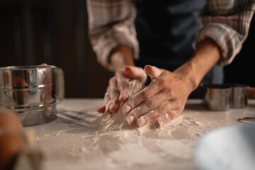 Hands delicately kneading dough in a charming rustic kitchen to prepare homemade bread
