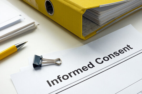 Informed consent documents and yellow folder.