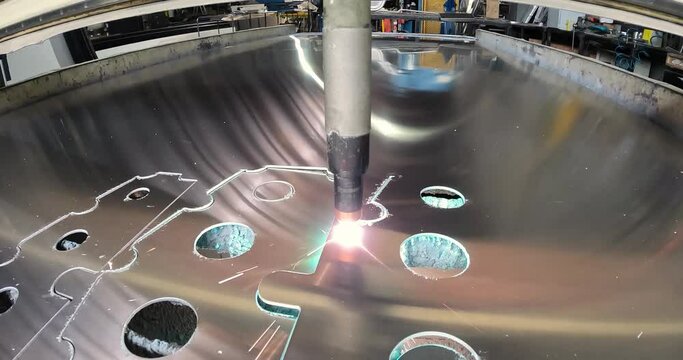 Plasma cutting. Plasma cutter work at the factory. The plasma cutter will cut the part. The process of cutting a metal part with a plasma cutter