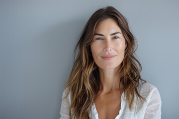 A close up portrait of a woman with a subtle smile