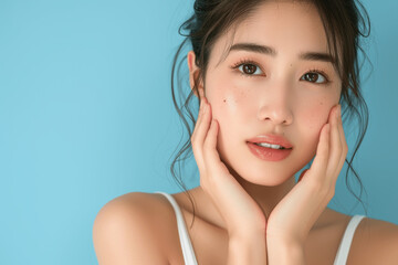 Japanese Beauty Woman with Flawless Skin on Light Blue Background