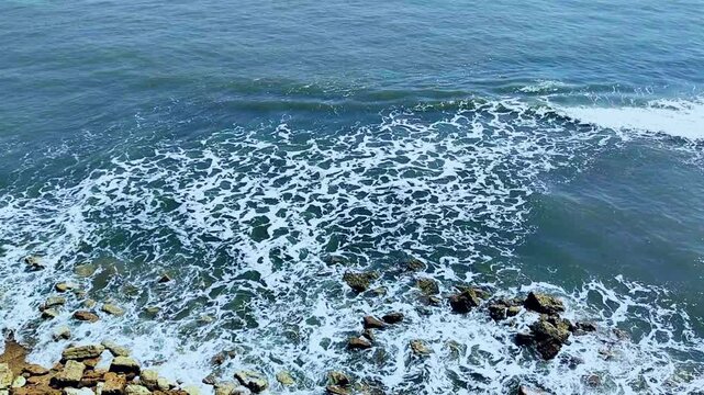 Aerial view of waves breaking over rocky coastline, Full HD