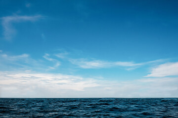 Panorama nature view clear sky with soft white cloudy background and soft oceans waves with a deep blue color on the sea