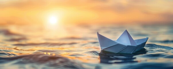 A paper boat is floating on the water. The sun is setting in the background. The water is calm and still. The paper boat is a symbol of hope and new beginnings.