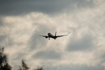 A passenger plane takes off at Tallinn airport on a summer day with clouds in the sky.