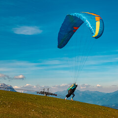 Alpine summer view with a paraglider taking off at Koessen, Kitzbuehel, Tyrol, Austria