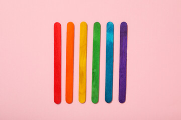LGBT parade concept, holiday symbols on pink background.
