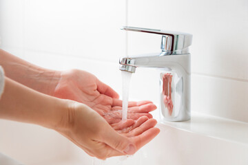 Sustainable use of natural resources banner. Clean tap water concept. Woman's hands with water near...