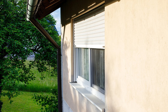 exterior view of a window in a house with roller shutters