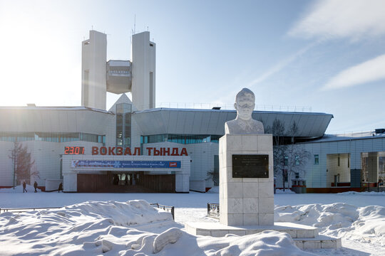 Tynda railway station, Tynda city, Amur region, Siberia, Russia - January 23, 2024. Winter view of the station building and the monument to Hero of the Soviet Union Viktor Miroshnichenko.