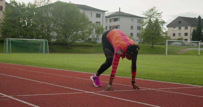 Female athlete ready to sprint on track field