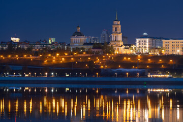 Obraz premium Perm city, Perm region, Russia. View of the Kama river embankment and the Transfiguration Cathedral. Architectural landmark of Perm. Beautiful night cityscape. Evening twilight. Travel to the Urals.