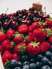 Tray with mixed berries: strawberries, blueberries, cherries close-up. Tray with berries