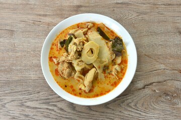 spicy boiled slice pickled bamboo shoot with chicken in coconut milk curry soup on plate 