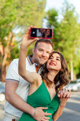 Young couple in love taking a selfie photo in the city