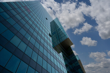 Vienna, Austria, August 17, 2022. Donau City is the city district characterized by modern skyscrapers, in the photo the detail of a glass facade. Play of reflections between the surfaces.