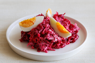 Beetroot salad with mayonnaise with cheese with egg on white background