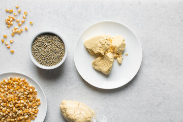 Overhead view of corn millet and nigerian akamu or pap, process of making akamu, flatlay of process of making nigerian akamu ogi pap or corn pudding
