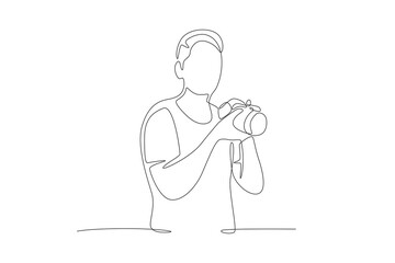Male photographer who will take photos. World photography day concept one-line drawing