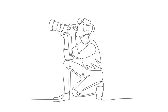 The male photographer who is taking photos is facing upwards while squatting. World photography day concept one-line drawing - Powered by Adobe