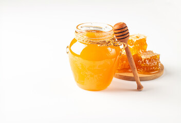 Honey dripping from a wooden honey dipper on white background. Healthy organic food concept. 
