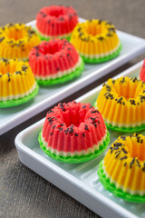 bolu kukus semangka or watermelon steamed sponge cake served on a white plate