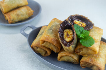 pisang coklat, a snack containing bananas and chocolate cooked by frying. It has a crunchy texture