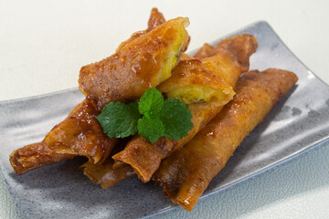 pisang caramel or pisang aroma Indonesian snack. Made from banana, sugar wrapped in flour sheet, cooked by frying