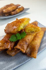 pisang caramel or pisang aroma Indonesian snack. Made from banana, sugar wrapped in flour sheet, cooked by frying
