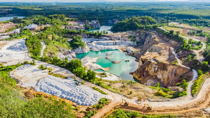 Aerial View of a Quarry with Turquoise Water and Surrounding Greenery, Showcasing Industrial and...