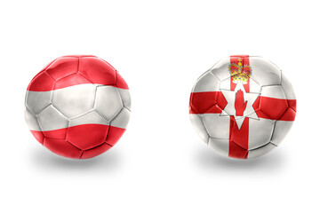 Obraz premium football balls with national flags of northern ireland and austria ,soccer teams. on the white background.