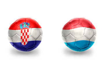 Obraz premium football balls with national flags of luxembourg and croatia ,soccer teams. on the white background.