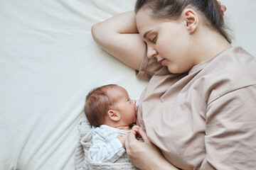 At-home lactation. Home breastfeeding area. Domestic nursing practice. Tired exhausted sleepless...