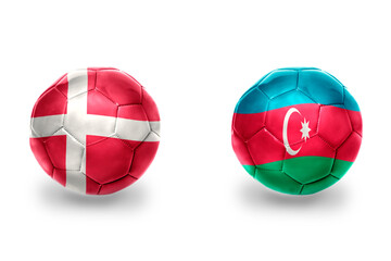 Obraz premium football balls with national flags of azerbaijan and denmark ,soccer teams. on the white background.