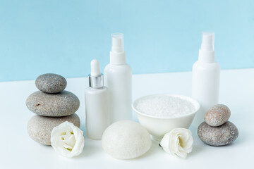 Spa set with white roses and blank bottles of skin care cosmetics