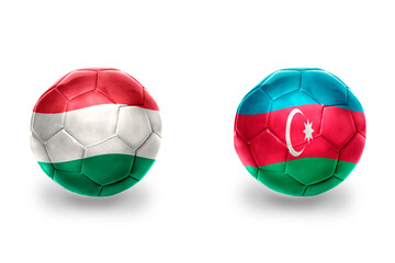 Obraz premium football balls with national flags of azerbaijan and hungary ,soccer teams. on the white background.