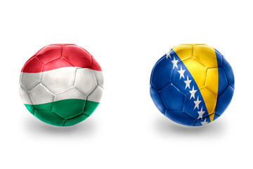 Obraz premium football balls with national flags of bosnia and herzegovina and hungary ,soccer teams. on the white background.