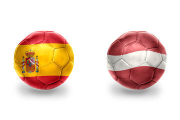 Obraz premium football balls with national flags of spain and latvia ,soccer teams. on the white background.