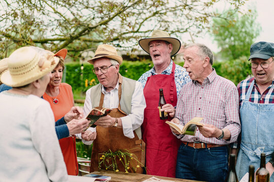 Senior Group Singing and Reading Outdoors - Friendship and Joy