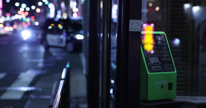 A night telephone box at the downtown in Tokyo handheld
