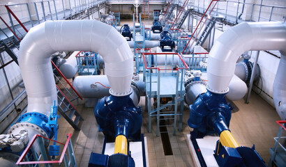 Industrial water pumping station interior with pipes and machinery