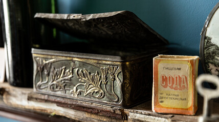 Vintage Metal Box with Soda Packet on Wooden Shelf is charming in a rustic, retro interior