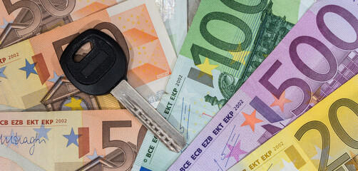 Car keys on paper Euro money for buying and renting