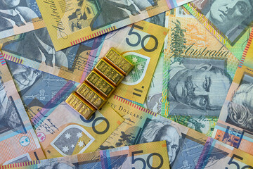 Aussie aud australian dollar banknotes on gold bars. Saving investment concept
